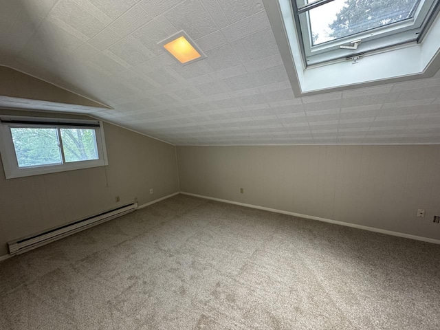 bonus room with baseboard heating, carpet floors, lofted ceiling, and baseboards