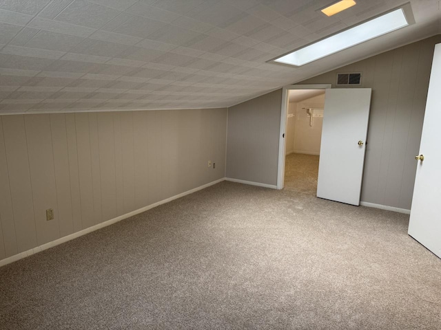 bonus room featuring carpet floors and vaulted ceiling