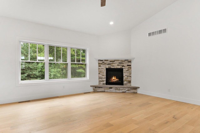 80 Oak Ridge Trl, Deerfield, WI 53531 - unfurnished living room with light wood-style floors, baseboards, a ceiling fan, a fireplace, and lofted ceiling