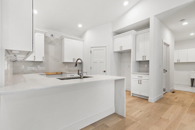 80 Oak Ridge Trl, Deerfield, WI 53531 - kitchen with a sink, light wood-style floors, white cabinets, recessed lighting, and a peninsula