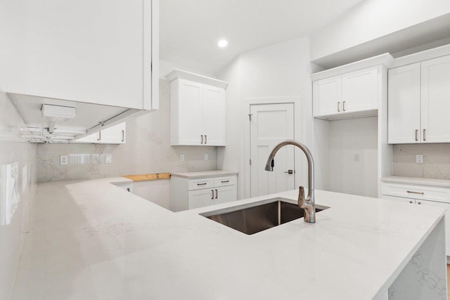 80 Oak Ridge Trl, Deerfield, WI 53531 - kitchen featuring a sink, light stone countertops, white cabinets, recessed lighting, and decorative backsplash