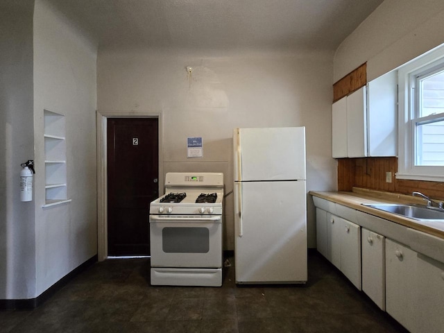 902 S 25th St, Milwaukee, WI 53204 - kitchen featuring white appliances, a sink, white cabinets, and light countertops