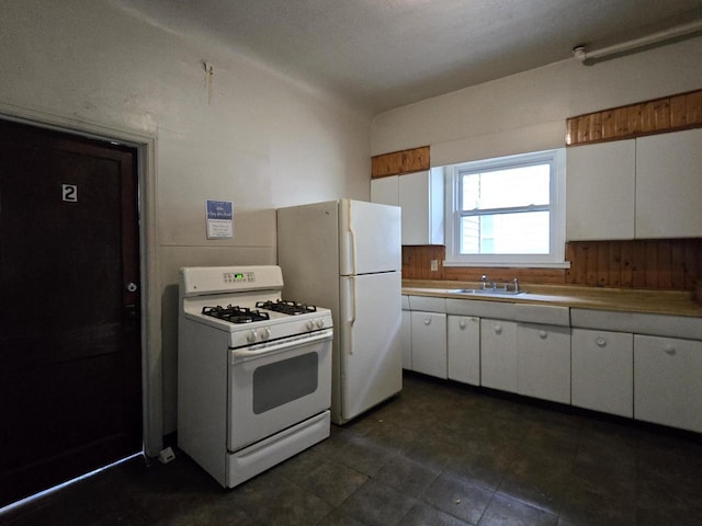 902 S 25th St, Milwaukee, WI 53204 - kitchen featuring white appliances, a sink, and white cabinetry