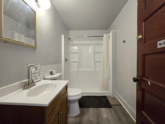 902 S 25th St, Milwaukee, WI 53204 - bathroom featuring wood finished floors, a shower stall, toilet, vanity, and baseboards