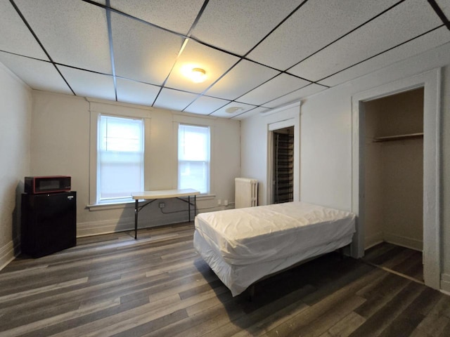 902 S 25th St, Milwaukee, WI 53204 - bedroom with radiator, wood finished floors, baseboards, and a drop ceiling