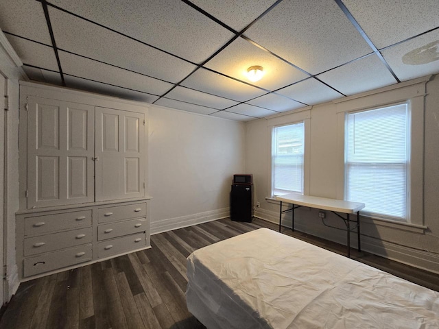 902 S 25th St, Milwaukee, WI 53204 - bedroom featuring a drop ceiling, baseboards, and dark wood-type flooring