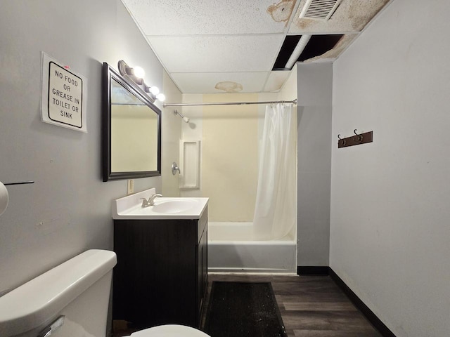 902 S 25th St, Milwaukee, WI 53204 - bathroom with a drop ceiling, toilet, wood finished floors, vanity, and shower / bath combo with shower curtain