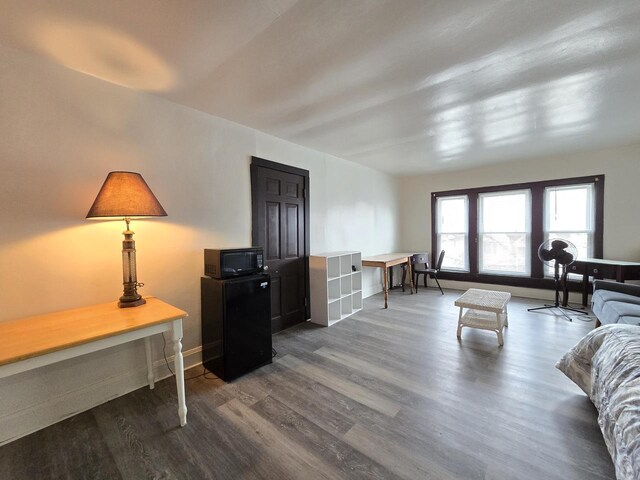 902 S 25th St, Milwaukee, WI 53204 - living area with dark wood-style floors, baseboards, and an office area