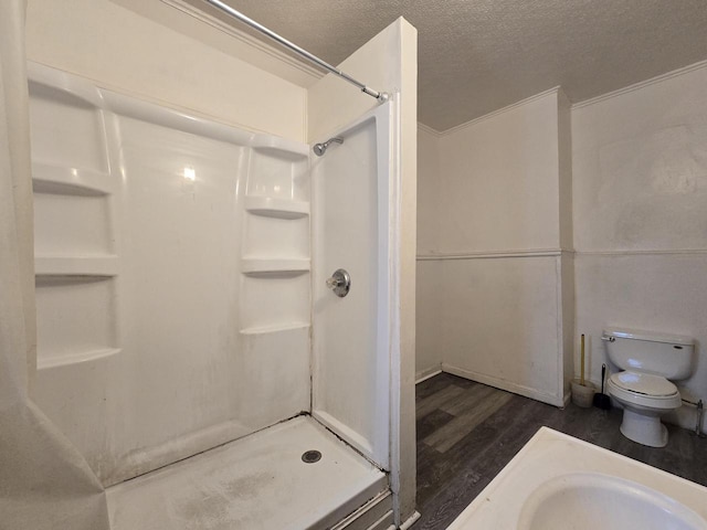 837 S 19th St, Milwaukee, WI 53204 - bathroom featuring wood finished floors, a shower stall, toilet, and a textured ceiling