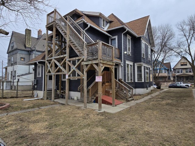 837 S 19th St, Milwaukee, WI 53204 - rear view of house featuring roof with shingles, a balcony, fence, and stairway