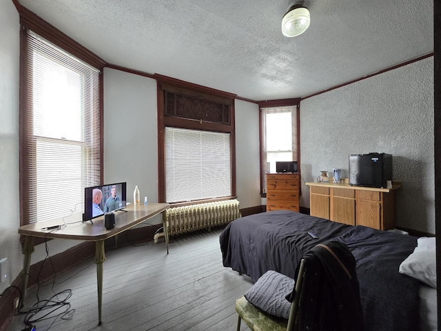 837 S 19th St, Milwaukee, WI 53204 - bedroom featuring a textured wall, radiator heating unit, a textured ceiling, crown molding, and wood-type flooring