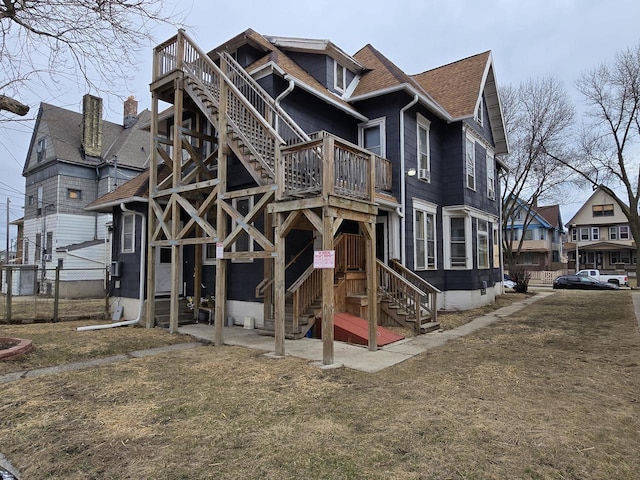 837 S 19th St, Milwaukee, WI 53204 - rear view of house featuring roof with shingles, a balcony, fence, and stairway