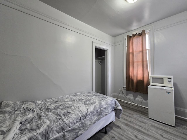 837 S 19th St, Milwaukee, WI 53204 - bedroom featuring wood finished floors, a closet, and baseboards
