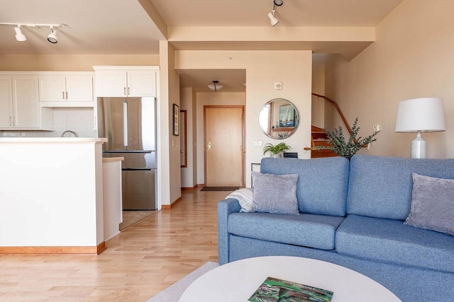 360 W Washington Ave Unit 1412, Madison, WI 53703 - living area with track lighting, light wood-type flooring, and baseboards