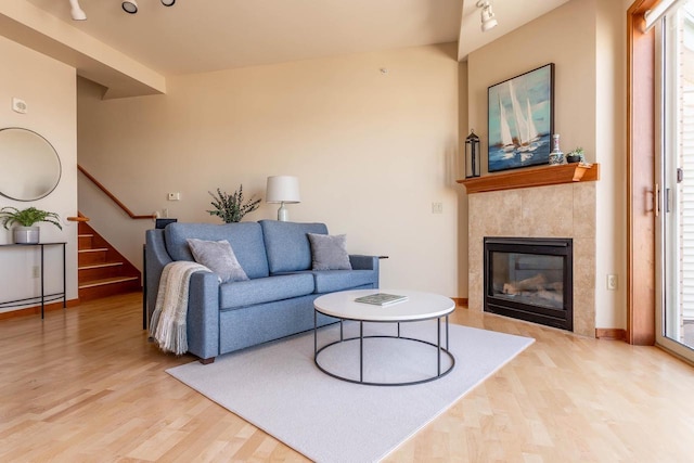 360 W Washington Ave Unit 1412, Madison, WI 53703 - living room with light wood finished floors, stairway, a fireplace, and baseboards