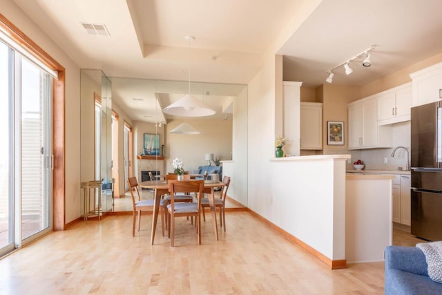360 W Washington Ave Unit 1412, Madison, WI 53703 - dining area with light wood-type flooring and baseboards