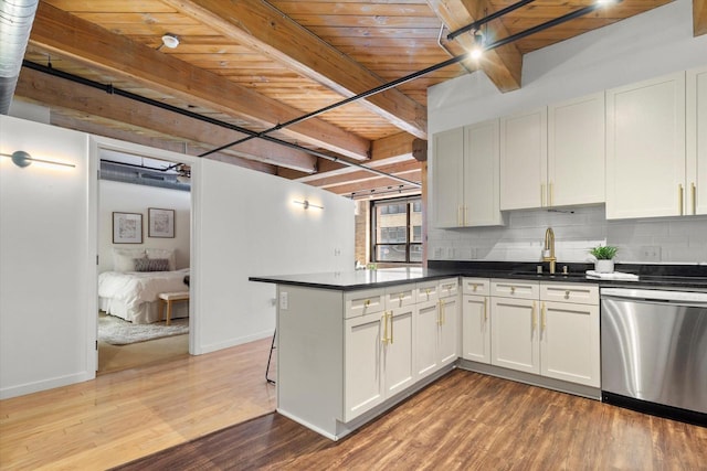 234 E Reservoir Ave Unit 104, Milwaukee, WI 53212 - kitchen featuring dishwasher, a sink, wood ceiling, beam ceiling, and tasteful backsplash