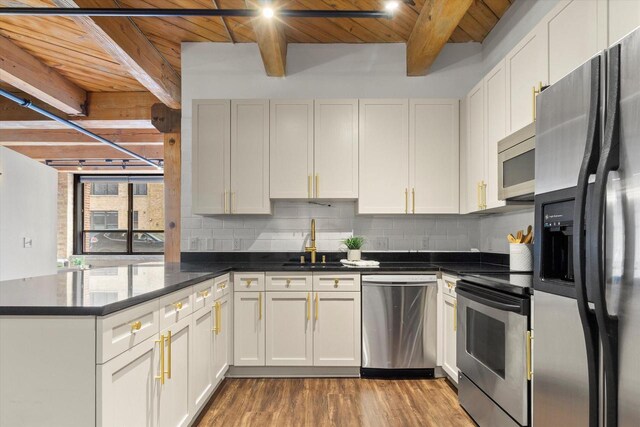 234 E Reservoir Ave Unit 104, Milwaukee, WI 53212 - kitchen with appliances with stainless steel finishes, a sink, beam ceiling, wooden ceiling, and a peninsula