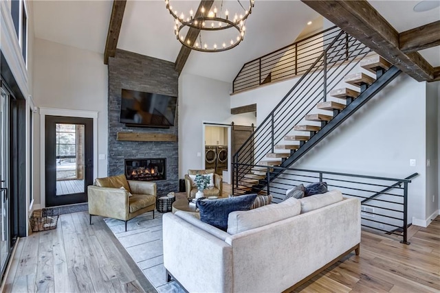 2936 W Sunset Bay, Birchwood, WI 54817 - living area featuring washer and dryer, high vaulted ceiling, hardwood / wood-style floors, baseboards, and a fireplace