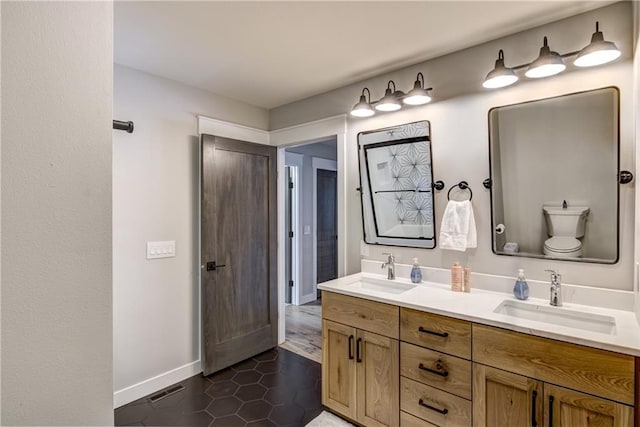 2936 W Sunset Bay, Birchwood, WI 54817 - full bath with tile patterned floors, baseboards, double vanity, and toilet