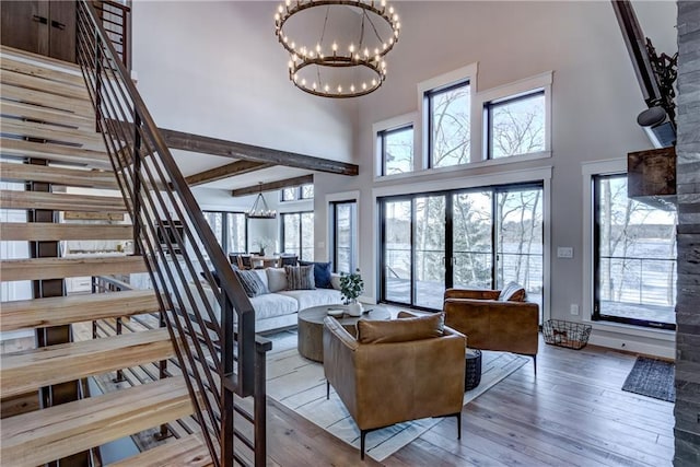 2936 W Sunset Bay, Birchwood, WI 54817 - living area featuring a towering ceiling, a chandelier, hardwood / wood-style flooring, stairs, and healthy amount of natural light