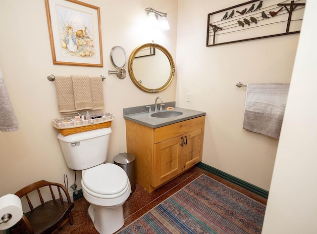 6209 Cassidy Rd, Mineral Point, WI 53565 - half bathroom featuring baseboards, toilet, vanity, and speckle patterned floor