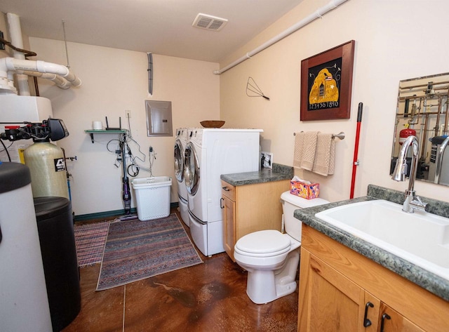 6209 Cassidy Rd, Mineral Point, WI 53565 - bathroom featuring electric panel, separate washer and dryer, concrete floors, vanity, and toilet