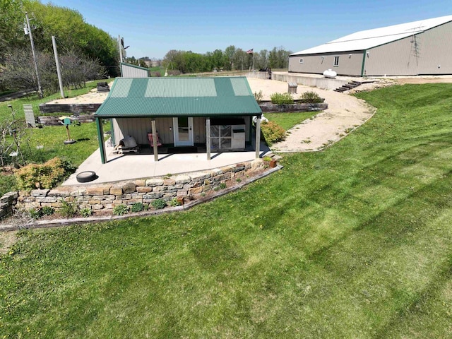 6209 Cassidy Rd, Mineral Point, WI 53565 - back of property featuring a patio area, a lawn, and metal roof