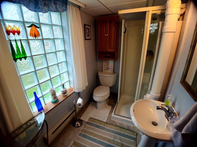 5449 Old Middleton Rd, Madison, WI 53705 - bathroom featuring toilet, a stall shower, a sink, and tile patterned flooring
