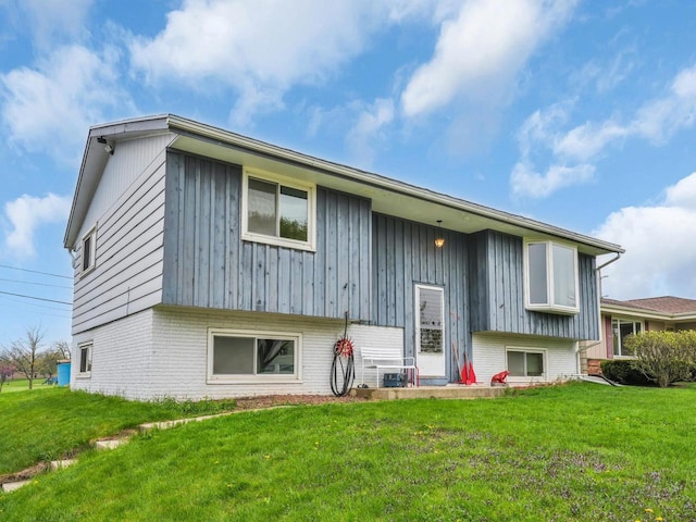 4715 Westway Ave, Racine, WI 53406 - back of property with a lawn, brick siding, and board and batten siding