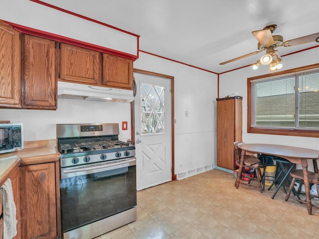 4715 Westway Ave, Racine, WI 53406 - kitchen featuring stainless steel range with gas cooktop, under cabinet range hood, a ceiling fan, and brown cabinetry