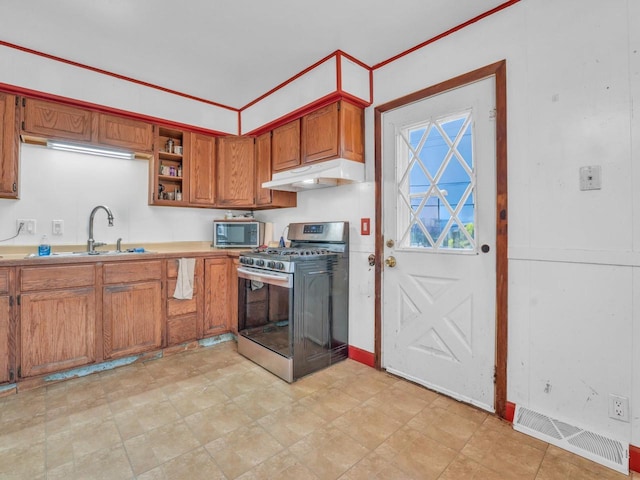 4715 Westway Ave, Racine, WI 53406 - kitchen with stainless steel appliances, under cabinet range hood, a sink, brown cabinets, and light countertops