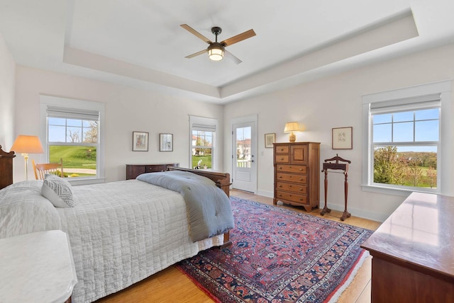 1387 Wilmington Way Unit 3-34, Lake Geneva, WI 53147 - bedroom with a raised ceiling, light wood-type flooring, baseboards, and a ceiling fan