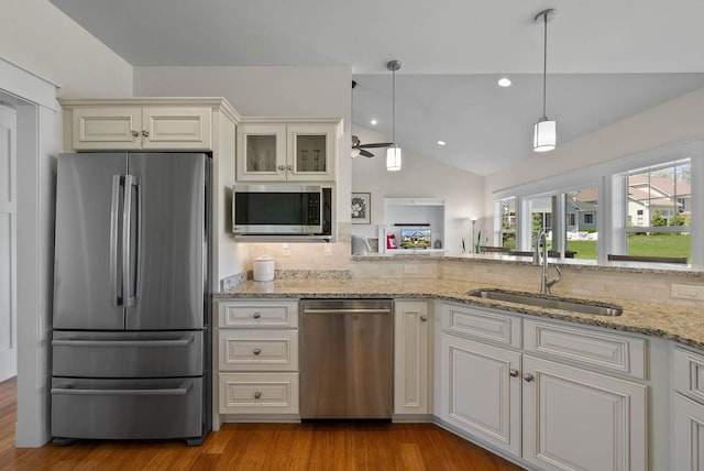 1387 Wilmington Way Unit 3-34, Lake Geneva, WI 53147 - kitchen featuring stainless steel appliances, a sink, a ceiling fan, lofted ceiling, and backsplash