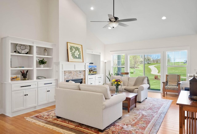 1387 Wilmington Way Unit 3-34, Lake Geneva, WI 53147 - living room with high vaulted ceiling, a ceiling fan, light wood-style flooring, a tile fireplace, and recessed lighting