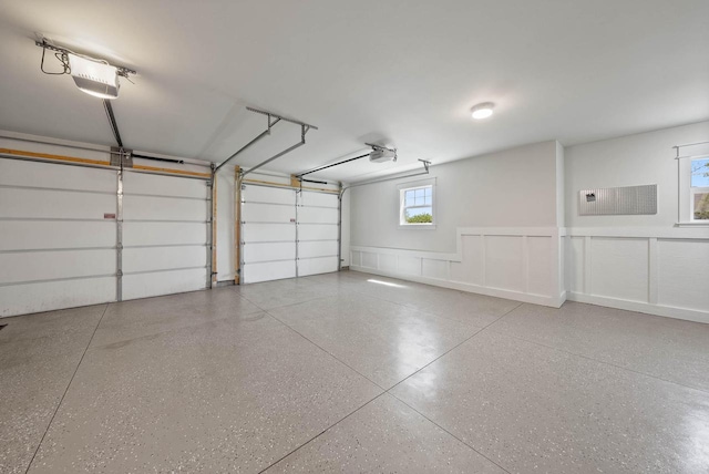 1387 Wilmington Way Unit 3-34, Lake Geneva, WI 53147 - garage featuring a garage door opener and a wainscoted wall