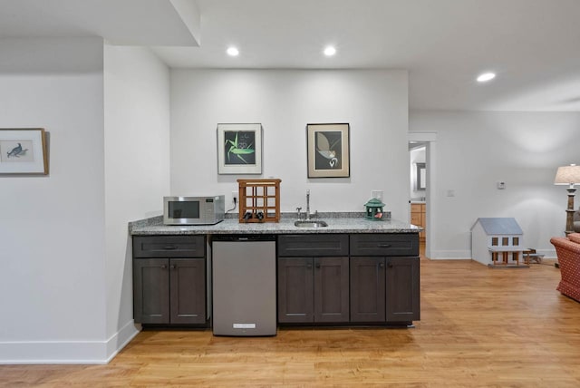 1387 Wilmington Way Unit 3-34, Lake Geneva, WI 53147 - bar with stainless steel microwave, a sink, light wood-type flooring, baseboards, and recessed lighting