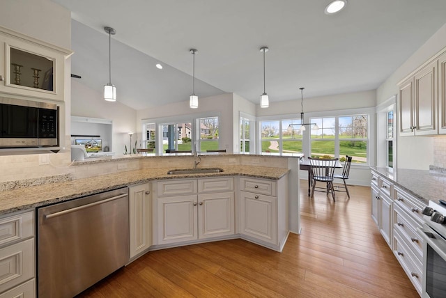 1387 Wilmington Way Unit 3-34, Lake Geneva, WI 53147 - kitchen with appliances with stainless steel finishes, a sink, decorative backsplash, light wood-style floors, and recessed lighting