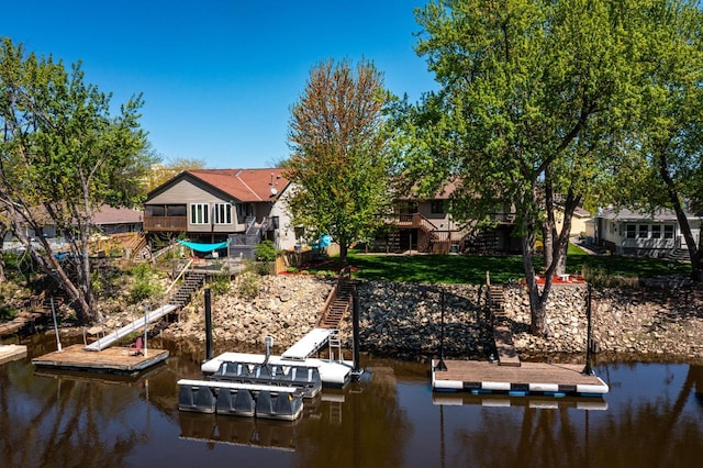 dock area featuring stairway and a water view