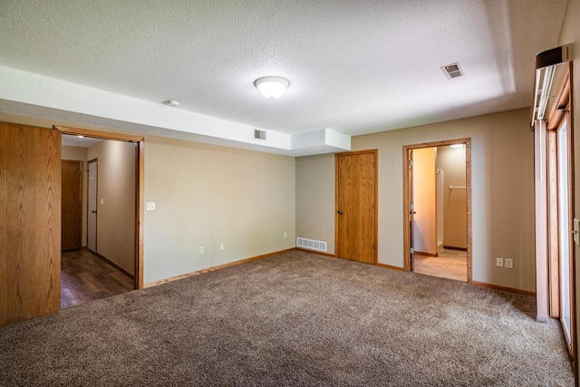 unfurnished bedroom with carpet floors, baseboards, and a textured ceiling