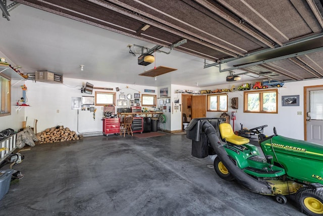 garage featuring a garage door opener and a workshop area