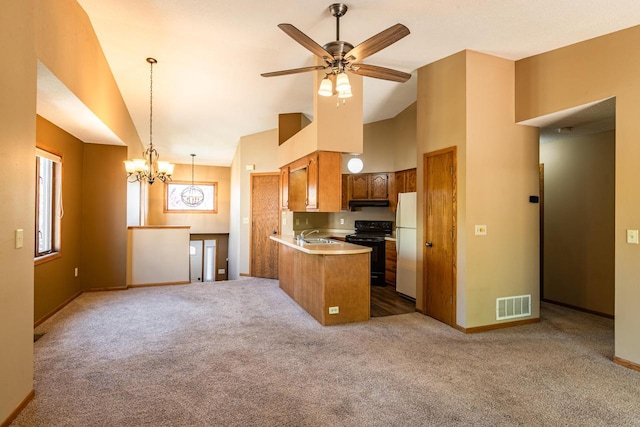 kitchen featuring electric range, freestanding refrigerator, light colored carpet, brown cabinets, and high vaulted ceiling
