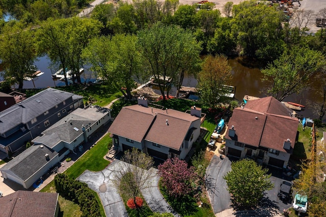 aerial perspective of suburban area with a nearby body of water