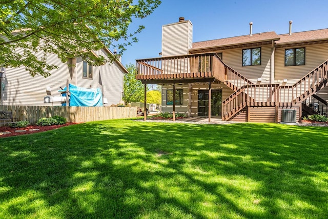 rear view of property featuring a chimney, stairway, a deck, a shingled roof, and central AC unit