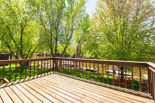 wooden terrace featuring a lawn
