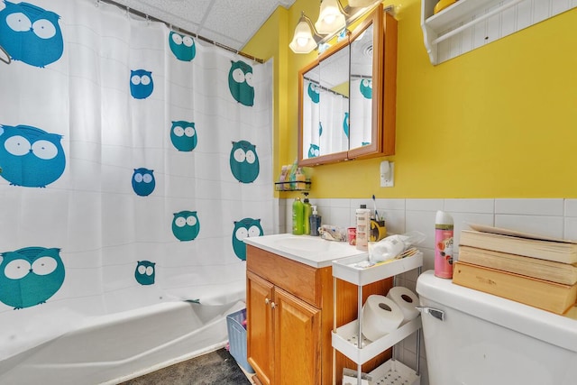 2936 S 9th Pl, Milwaukee, WI 53215 - bathroom with tile walls, vanity, shower / bathtub combination with curtain, a drop ceiling, and toilet