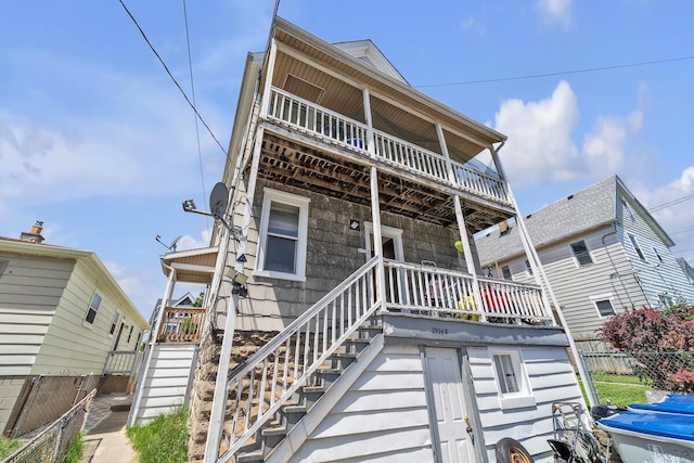 2936 S 9th Pl, Milwaukee, WI 53215 - view of property with stairway, fence, and a balcony