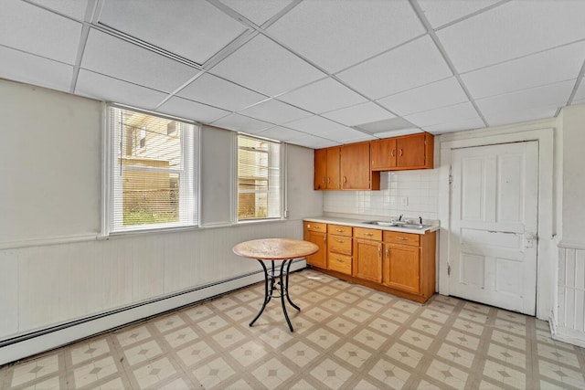 2936 S 9th Pl, Milwaukee, WI 53215 - kitchen featuring baseboard heating, a sink, light flooring, light countertops, and a drop ceiling