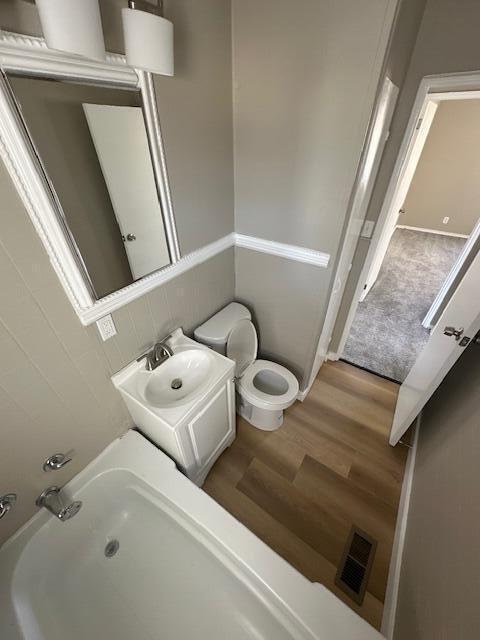 bathroom with wood finished floors and toilet