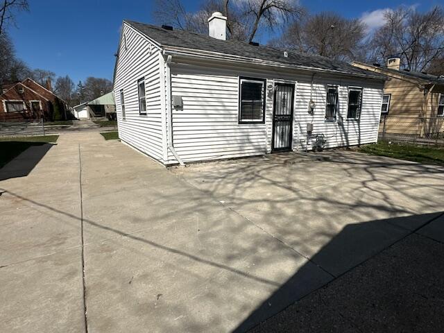 back of property featuring a chimney